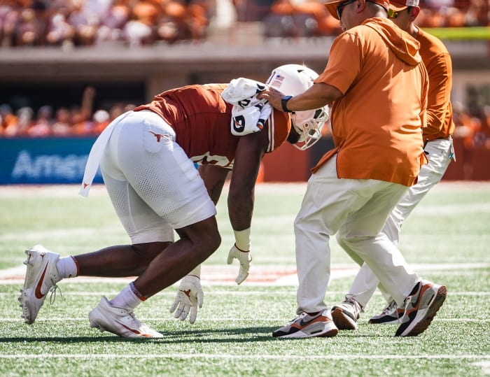 Texas tight end Ja'Tavion Sanders (0) is helped off the field by Texas staff in the first quarter of the Longhorns' game against the Kansas Jayhawks, Saturday, Sept. 30 at Darrell K Royal-Texas Memorial Stadium